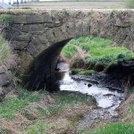 Bridge-Stone arch, on 125th St. between Dogwood Ave., and Dove Ave, Monona Township